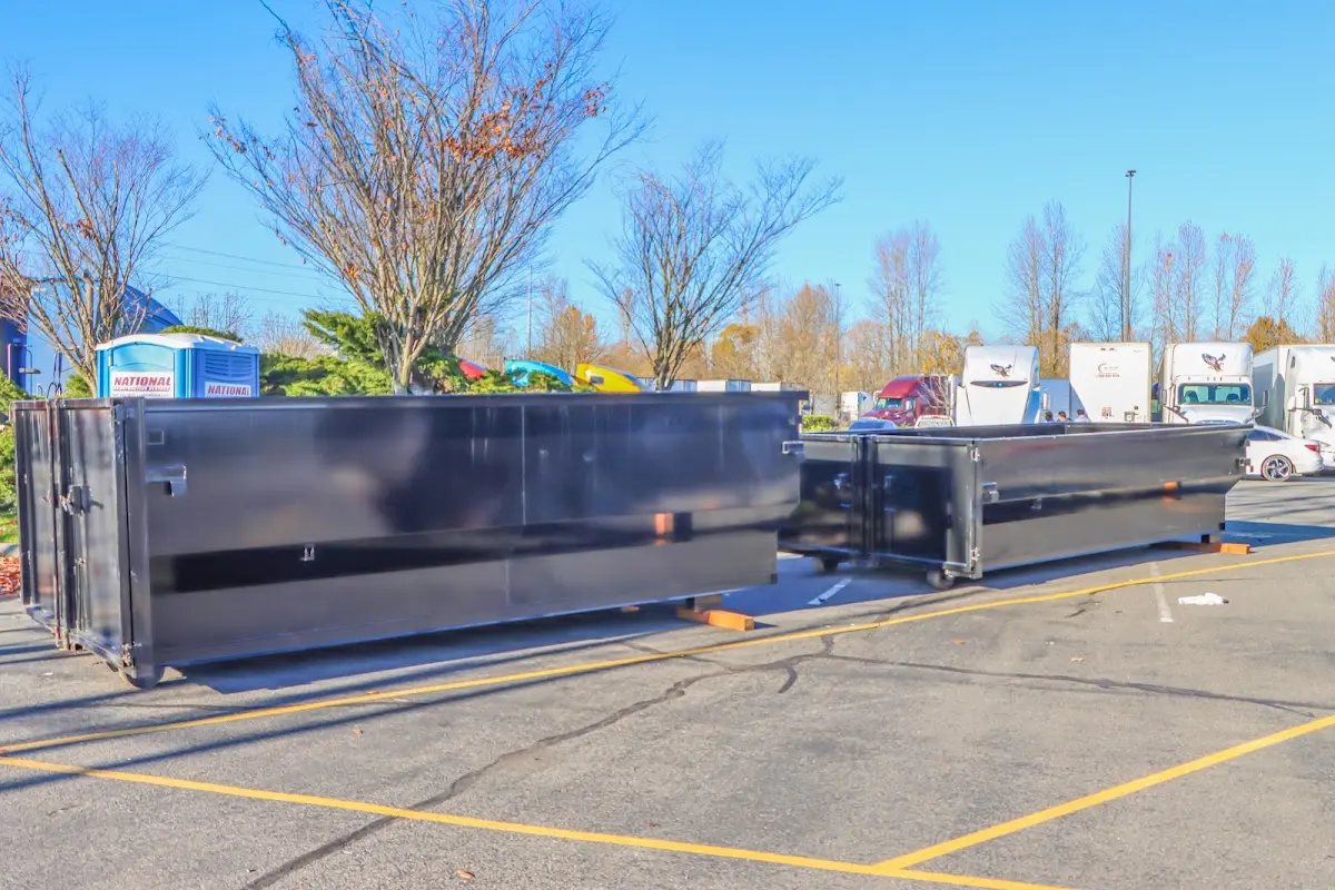 Professional dumpster rental service with roll-off container on residential driveway in Coralville